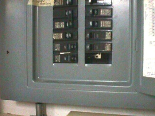 A close up of an electrical panel with the breakers on